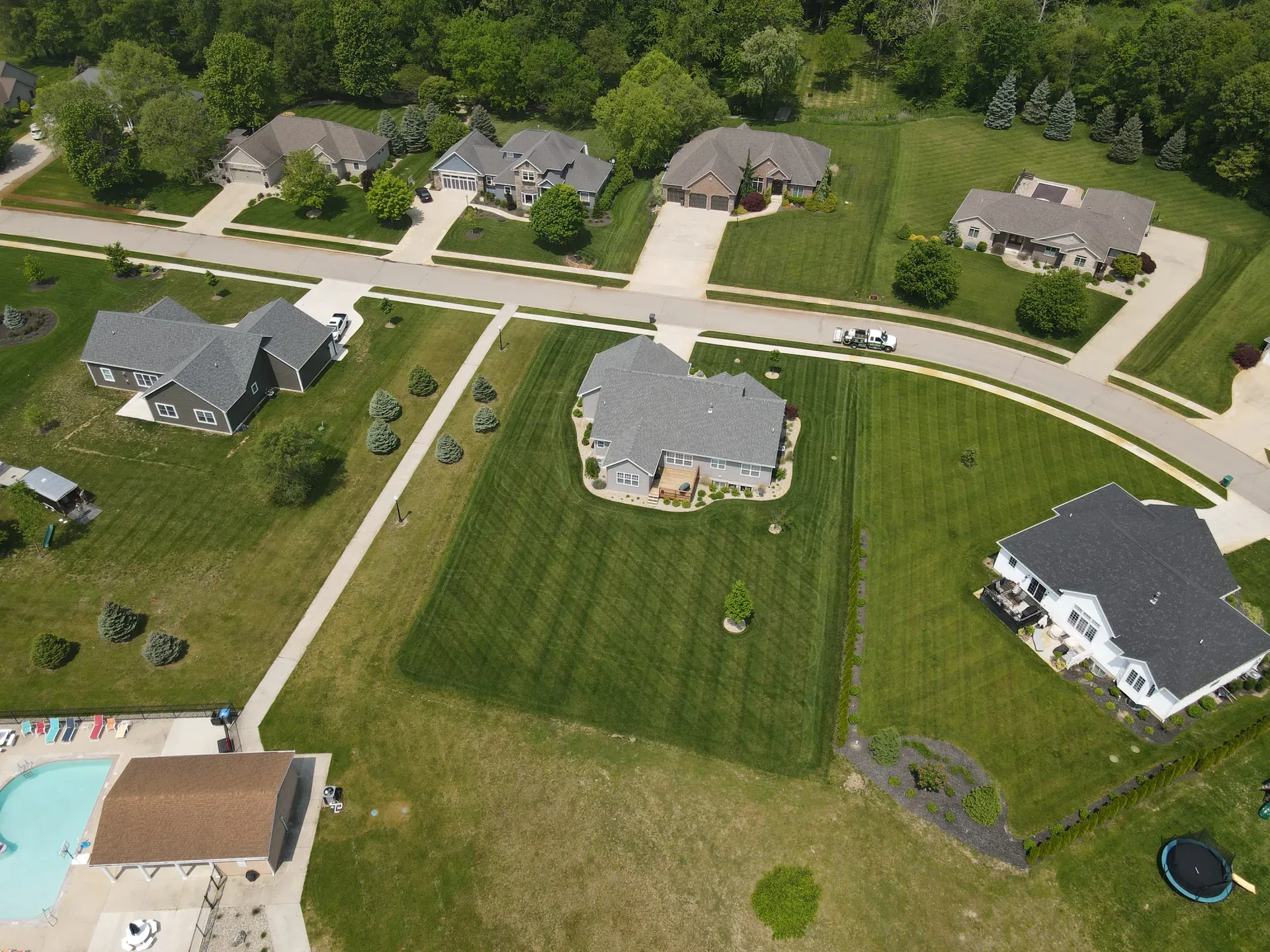 An aerial view of a northern Indiana neighborhood with green front lawns