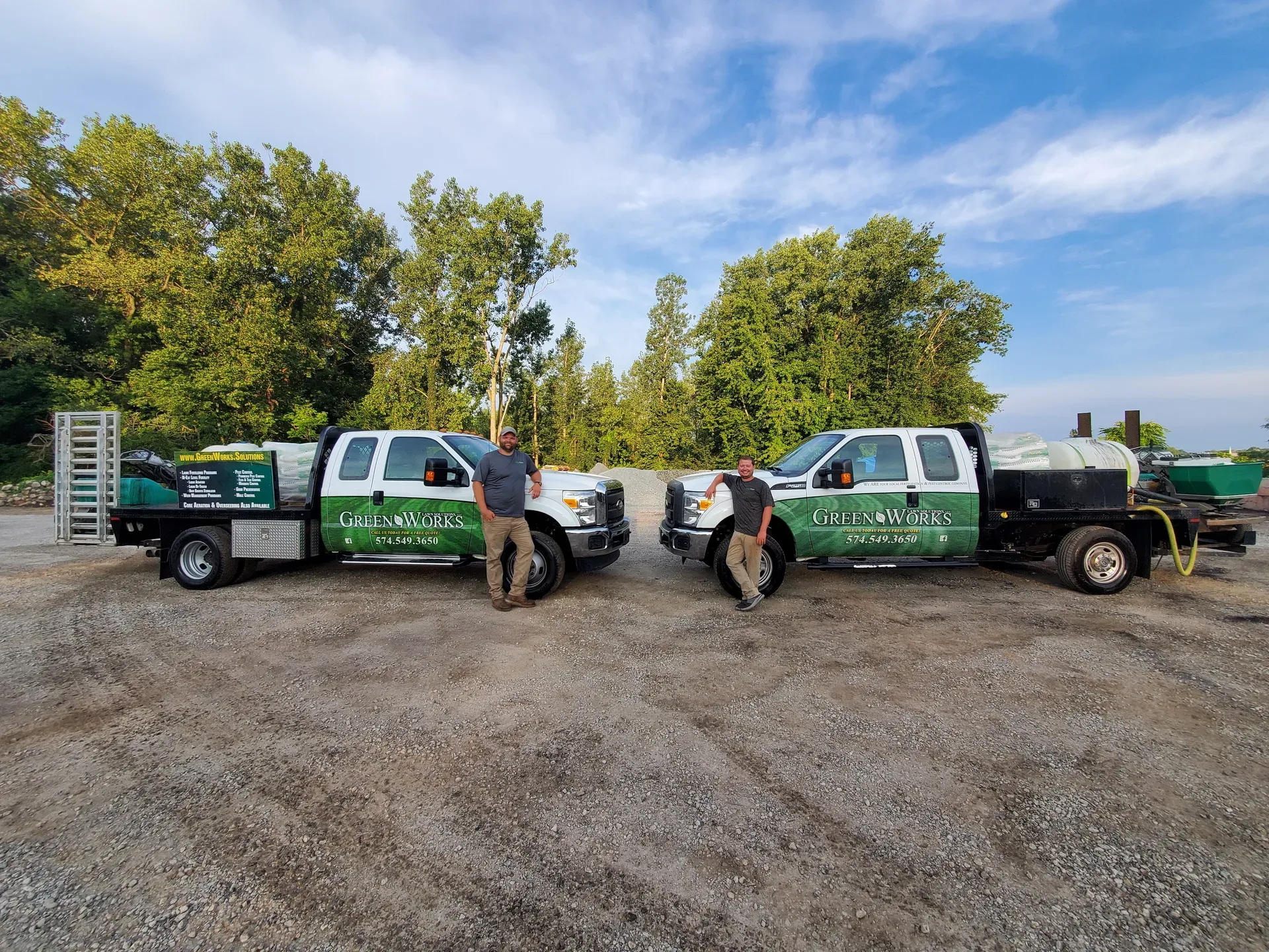 The GreenWorks Lawn Solutions crew standing beside two of their trucks