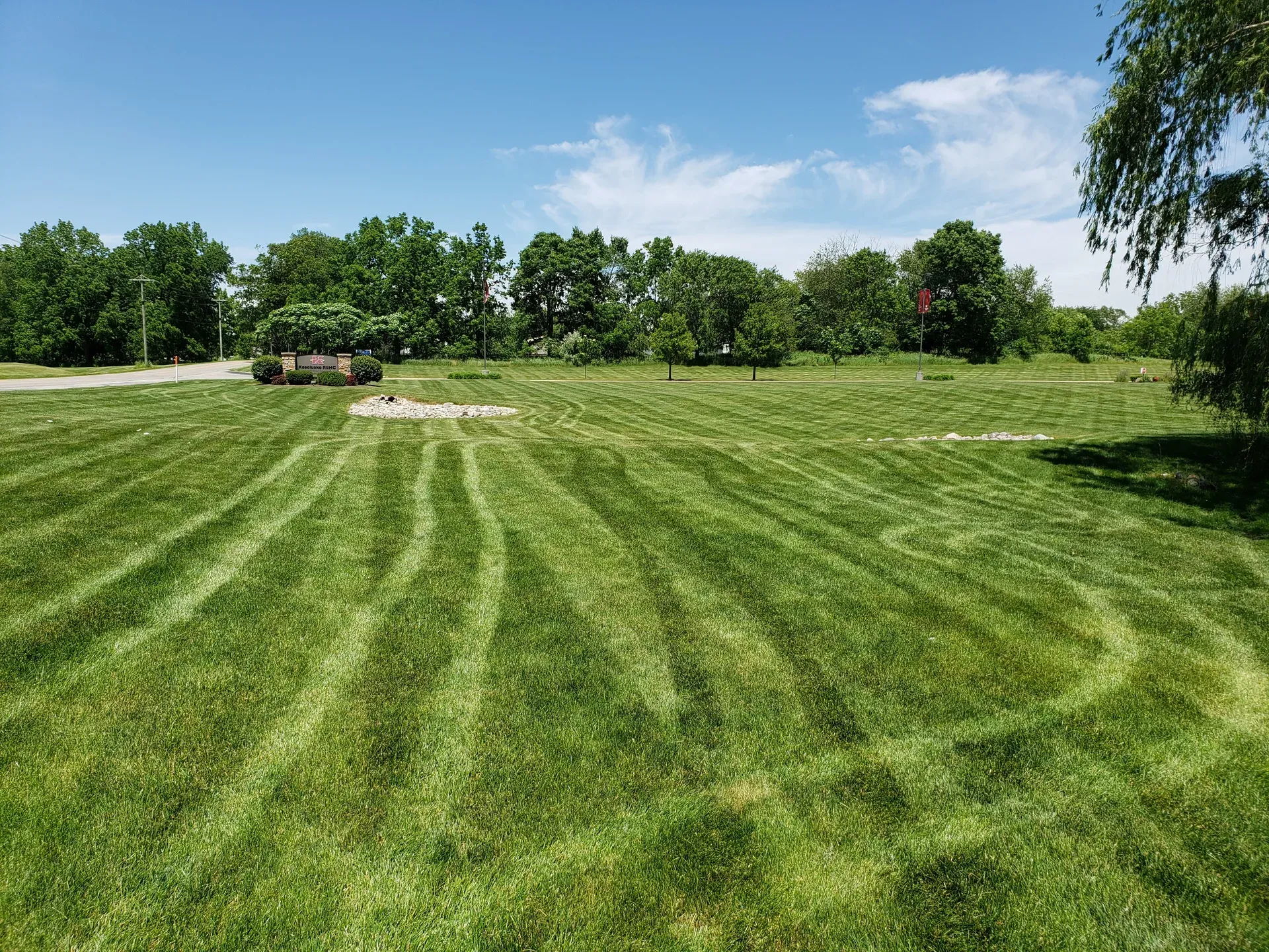 A wide, well-kept lawn across a commercial campus in northern Indiana